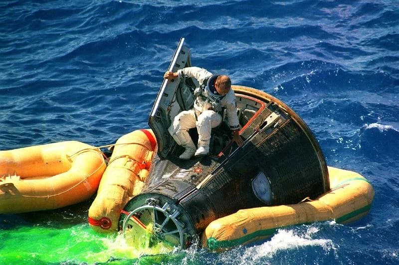 (091566) - Astronaut Charles Conrad Jr., command pilot of the Gemini 11 space mission, climbs from the spacecraft minutes after splashdown